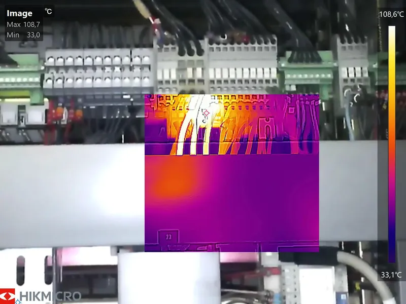 Contrôle d'une armoire électrique : incrustation du thermogramme sur l'image visible, point chaud mesuré à 108,7 °C sur un départ